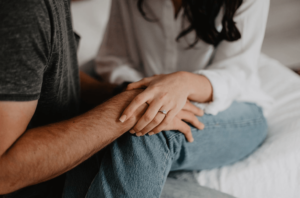 married couple holding each others wrist after they have couples therapy for infidelity